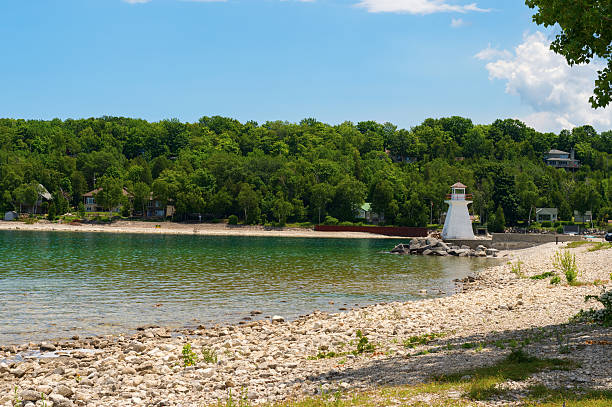 Lion's Head lighthouse set beneath the majestic Niagara escarpment. The first lighthouse was built in 1903 and was rebuild several times due to the harsh conditions of Georgian Bay. The High School students built a replica model that stands in its place today.