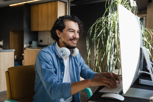 istock Young latin Man Working from Home on Desktop Computer or Creative Designer on home office in Mexico Latin America, hispanic people 1481612420