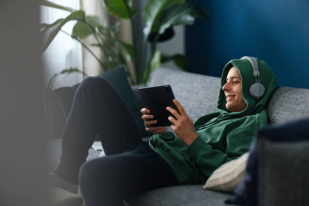istock Happy Teenage Boy Using A Digital Tablet At Home 1481612948