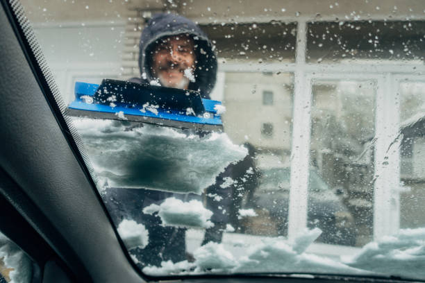 istock Winter, a man cleans the snow from the car 1481616690