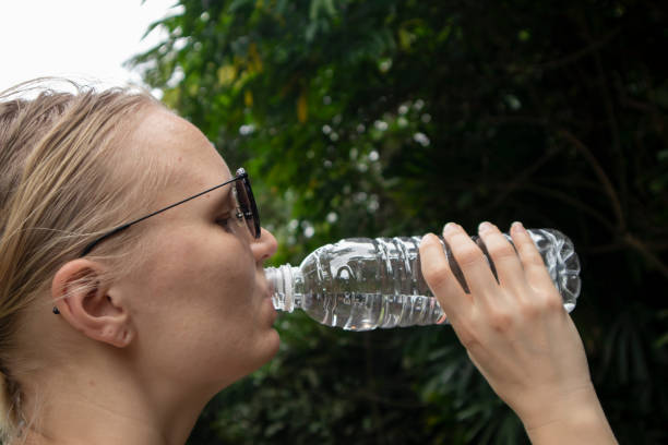 istock Woman drinking water from plastic bottle 1481618209