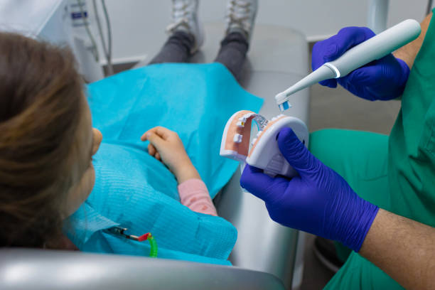 istock Friendly Dentist Explaining Treatment to Child 1481620461