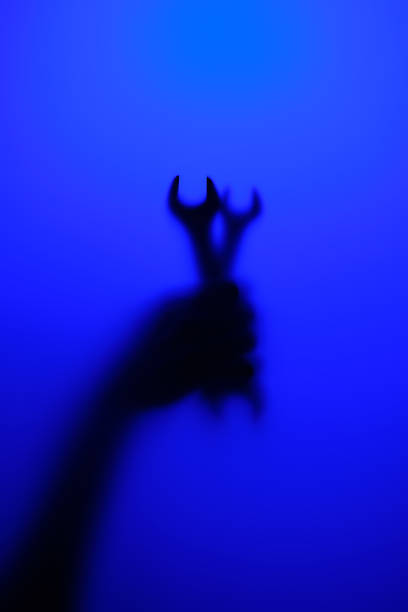 istock A neon-lit silhouette of a hand gripping a wrenches. 1481625779