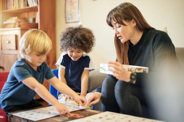 istock Teacher, children and together with puzzle in kindergarten, learning or mind development with diversity in class. Woman, boy kids or teaching game for problem solving, pattern and teamwork at school 1481625952