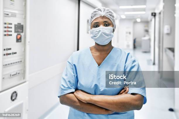 African Woman Doctor In Uniform Standing At Hospital Corridor Stock Photo - Download Image Now