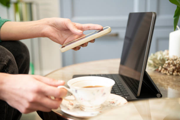 istock Woman works and uses a smart phone and notebook computer. 1481628624