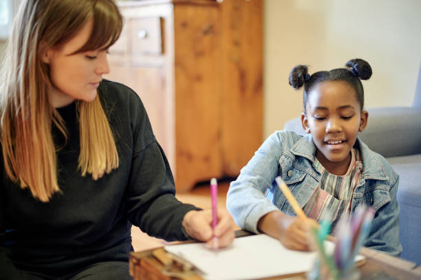 istock Family, teaching and child writing, drawing and talking in support, helping and creative learning or development. Biracial kid and mom, mother or woman with education, home school or color tutoring 1481629492