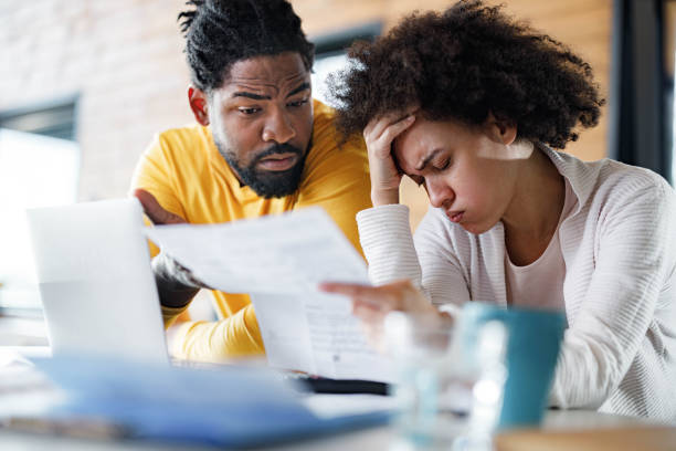 istock African American couple having problems with paying bills online at home. 1481629530