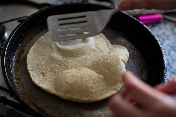 istock Cooking pita bread on a pan. 1481630517