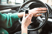 Woman using a smart watch in car