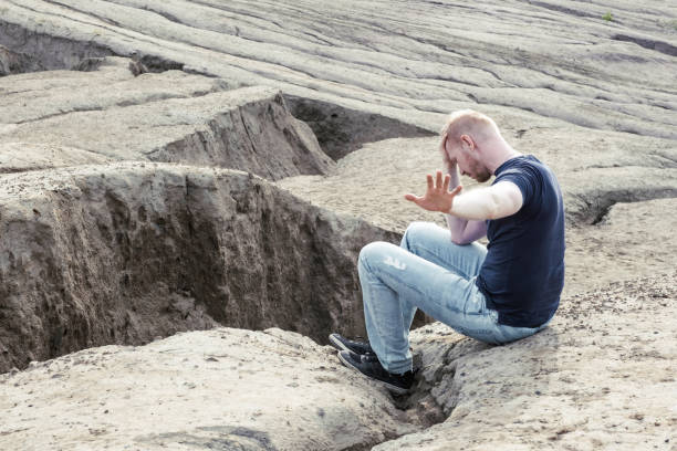 istock A man surrounded by mountains. Thoughtfulness and loneliness 1481635615