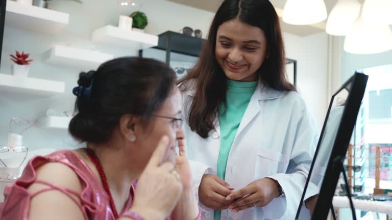 Optometrist helping client to choose eyeglasses