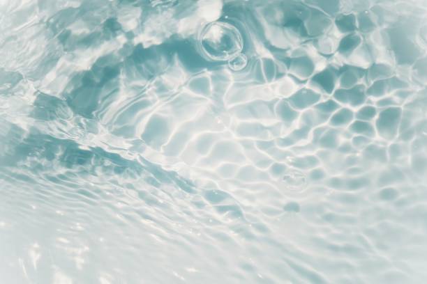 istock Defocus blurred transparent blue colored clear calm water surface texture with splashes and bubbles. Trendy abstract nature background. Water waves in sunlight with copy space. Blue water shine 1481636790