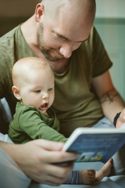 istock Family, father with baby and reading book with learning storytelling and development with early childhood and growth. Man, kid and story, bonding and love with care, learn language with words 1481637766