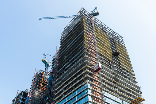 View of the building construction site with cranes in Taichung, Taiwan.