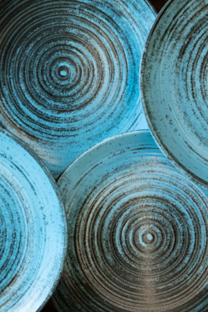 Ceramic set of blue empty kitchen plates on a white marble background. Eco and minimal tableware.