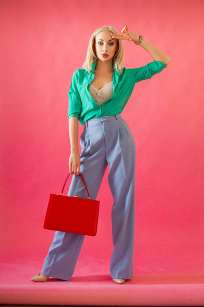 istock Glamorous woman with red handbag on pink background 1481641182