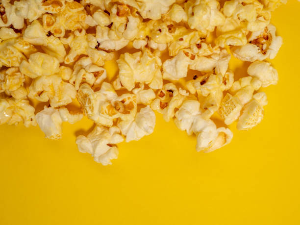 istock Popcorn on a yellow background. Sweet popcorn on yellow. 1481642348