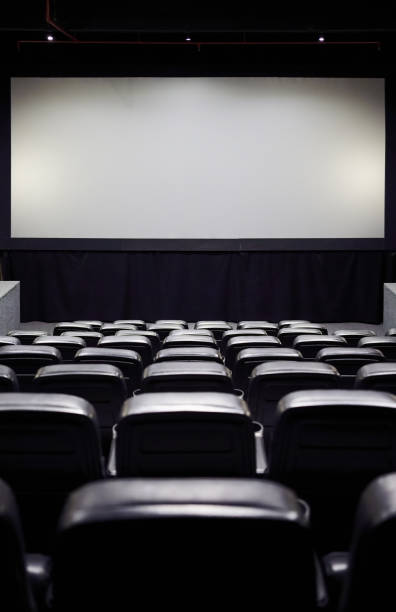 istock Empty movie theater with a blank white screen 1481644983