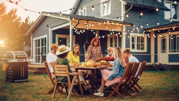 istock Group of Multiethnic Diverse People Having Fun, Communicating with Each Other and Eating at Outdoors Dinner. Family and Friends Gathered Outside Their Home on Warm Summer Day. 1481647374