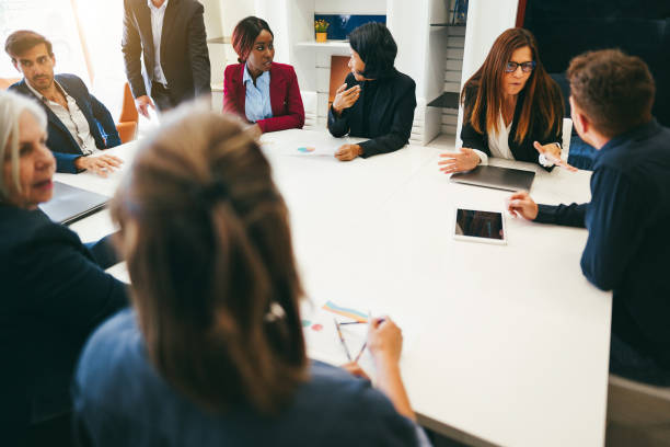 istock Multiracial colleagues working inside business office - Entrepreneurs people sharing ideas at teamwork meeting - Brainstorming concept - Main focus on african woman face 1481648390
