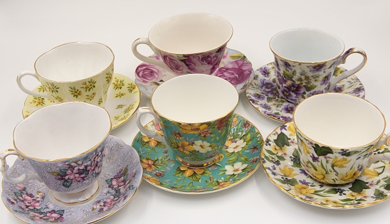 A collection of assorted ceramic teacups arranged on a tabletop