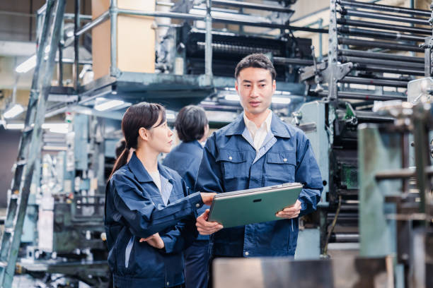 istock Staff discussing at the factory while looking at a tablet 1481654223