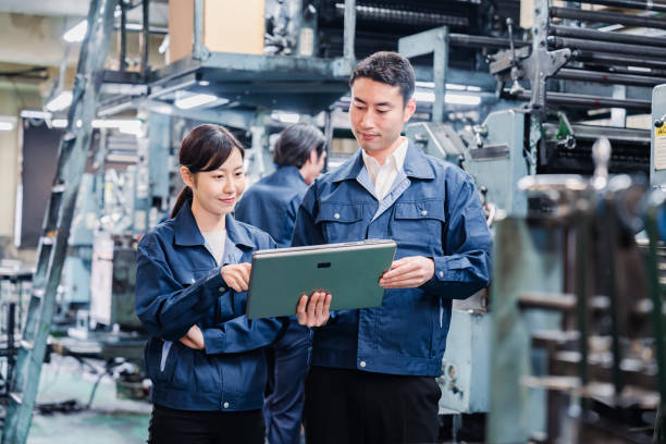 istock Staff discussing at the factory while looking at a tablet 1481654225