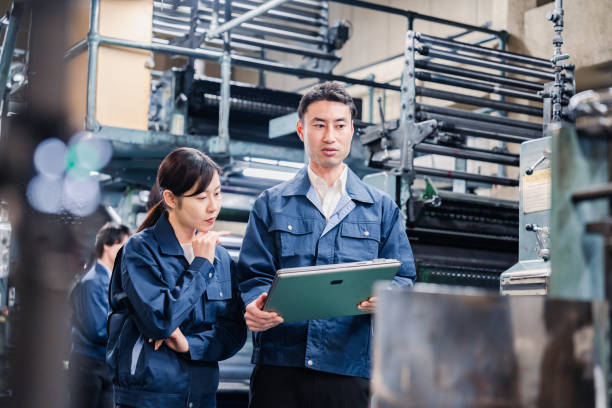istock Staff discussing at the factory while looking at a tablet 1481654239