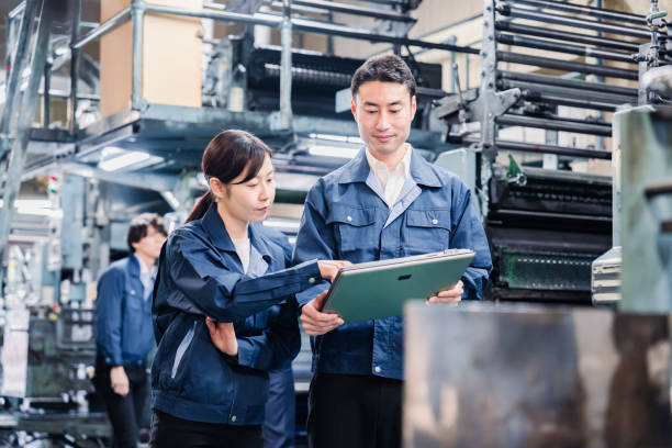 istock Staff discussing at the factory while looking at a tablet 1481654257
