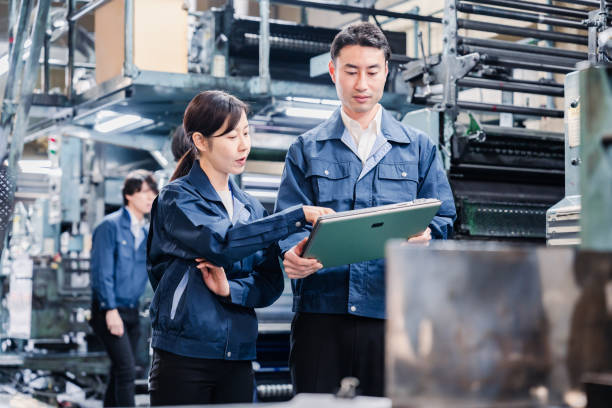 istock Staff discussing at the factory while looking at a tablet 1481654260