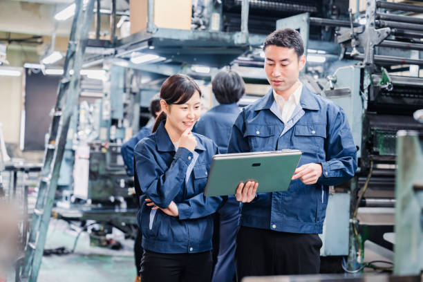 istock Staff discussing at the factory while looking at a tablet 1481654261