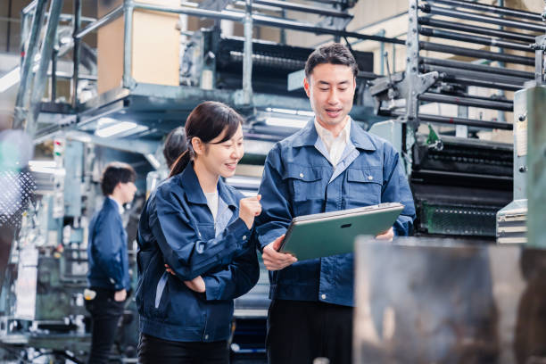 istock Staff discussing at the factory while looking at a tablet 1481654284
