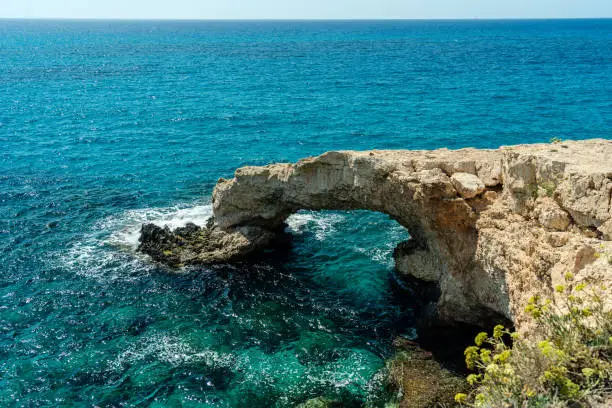 Photo of Azure sea around beautiful rocky arch