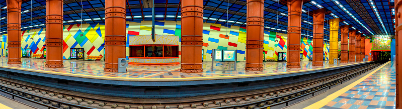 panoramic image of the colorful subway platform at Olaias in Lisbon.
