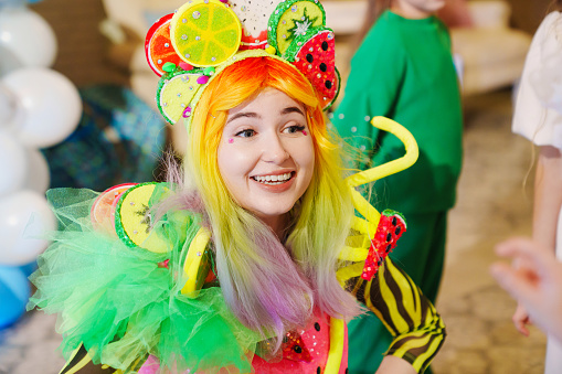 a young woman in a stage costume works as an animator at a children's party. entertainment for children.