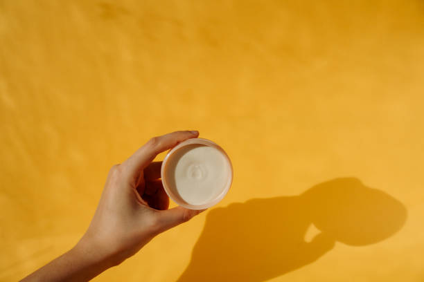 istock Hand holding cream in a pot 1481662047
