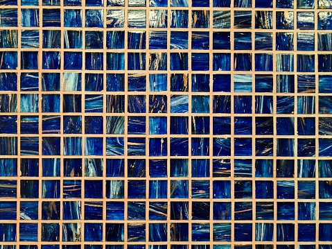 Blue colored tiles on the wall.