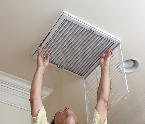 istock A senior man checking the air conditioner filter 148166983