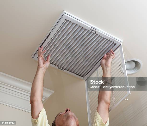 A Senior Man Checking The Air Conditioner Filter Stock Photo - Download Image Now - Air Purifier, Air Conditioner, Dirty