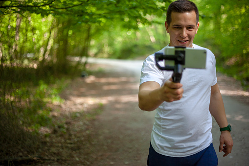 Man shooting with a smartphone connected to a gimbal
