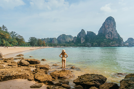 Cheerful young woman on the background of Railey  bay in Krabi