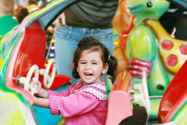 istock little girl playing on carousel 148167891