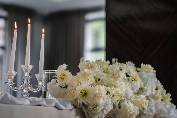 istock Festive table covered tablecloth, decorated composition flowers and candles in party area. Wedding setup detail. Table setting, serving closeup. Banquet decoration in hall restaurant. Luxury reception. 1481680648