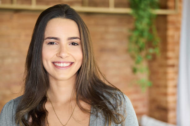 istock Young woman smiling while standing on her living room 1481684162