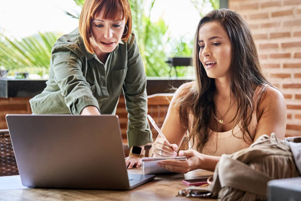 istock Two women working together on laptop at home 1481684329
