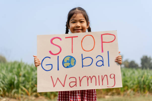 istock cute little girl looking at camera while standing in protest against climate change 1481684391