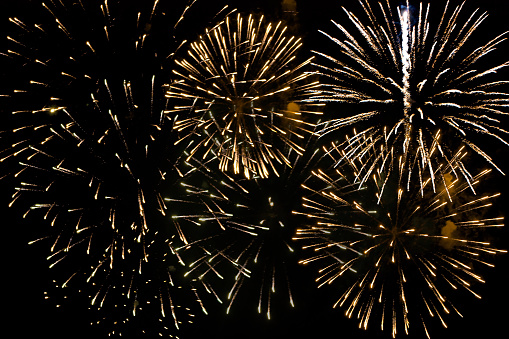 Gold colored fireworks full frame at night, celebration background. Galicia, Spain.