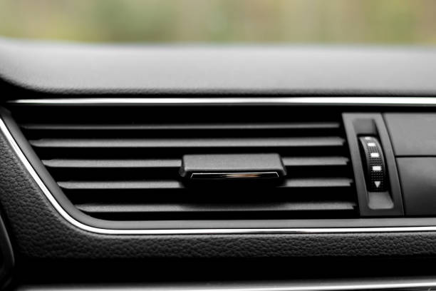 istock Air conditioner flow inside the car, plastic grid panel. Vehicle air conditioning close up view. Detail interior of modern car. Air ducts. Dashboard 1481695621