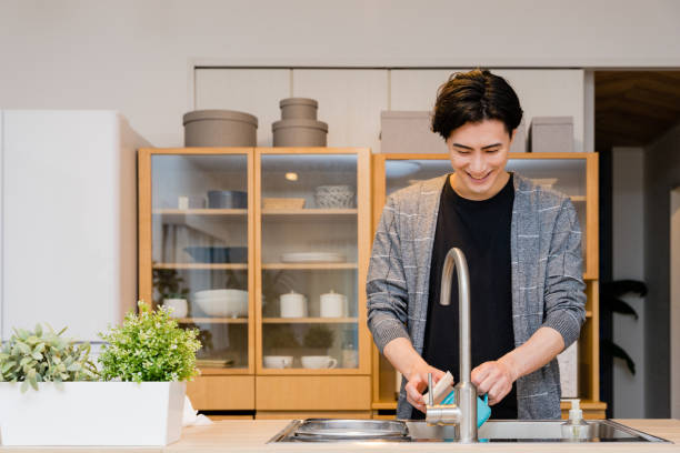 hombres de treinta años que lavan los platos en la cocina de casa - cleaning domestic kitchen counter top housework fotografías e imágenes de stock